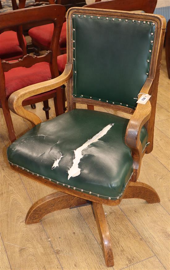 An early 20th century oak swivel desk chair